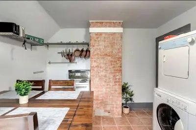 a kitchen with a brick pillar in a room at Oakwoods 1BR Suite in Bankview in Calgary
