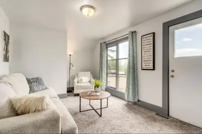 a living room with a couch and a table at Oakwoods 1BR Suite in Bankview in Calgary
