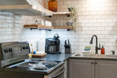 a kitchen with a stove and a sink at Whistler Lakeside Hideaway in Whistler