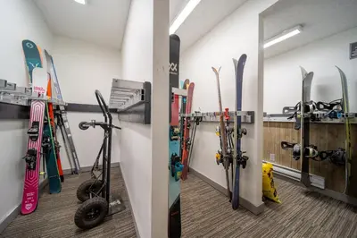 a room with skis and snowboards leaning against a wall at Whistler Lakeside Hideaway in Whistler