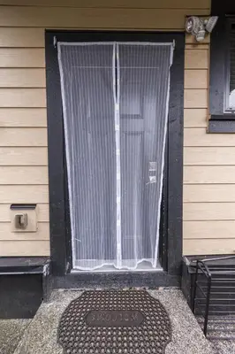 a door with a window with a curtain on it at Peaceful 2 Bedroom Suite that sleeps 4 with Free Wifi ,Free parking,easily accessible to Downtown Vancouver in Surrey