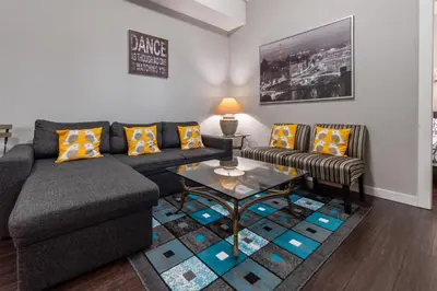 a living room with a couch and a table at Peaceful 2 Bedroom Suite that sleeps 4 with Free Wifi ,Free parking,easily accessible to Downtown Vancouver in Surrey