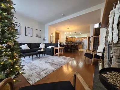 a living room with a christmas tree in it at Mountain Escape for Ski and Golf Enthusiasts in Kimberley