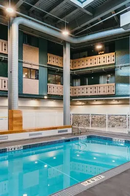 a large swimming pool in a building at The Lifty Ski-In Ski-Out Studio, Pool and Gym in Big White