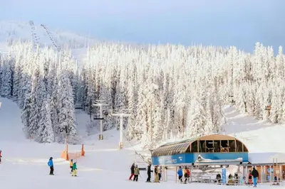 a group of people on a ski slope with a ski lift at The Dorm Ski-In Ski-Out Studio, Pool and Gym in Big White