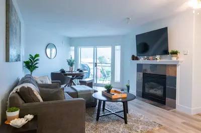 a living room with a couch and a fireplace at Echo Beach, 2 Bed, Lake View and Walkable to Beach in Harrison Hot Springs