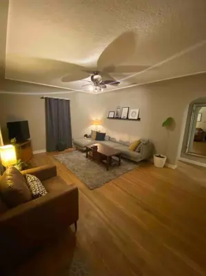 a living room with a couch and a table at Walk to the beaches and the restaurants downtown! in Kelowna