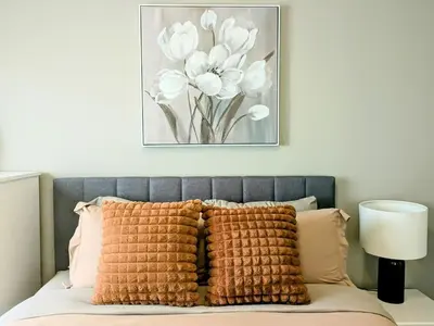 a bedroom with a bed with a picture on the wall at A Slice of Heaven in Airdrie by EaglesWingsHomes1 in Airdrie