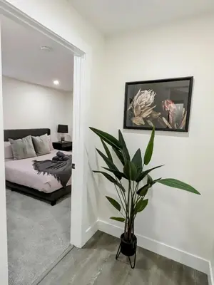 a living room with a couch and a potted plant at A Slice of Heaven in Chestermere in Calgary