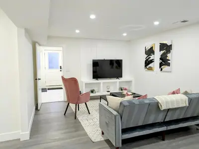 a living room with a couch and a tv at A Slice of Heaven in Chestermere in Calgary