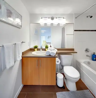 a bathroom with a toilet and a sink and a tub at Stylish Condo in Downtown in Vancouver