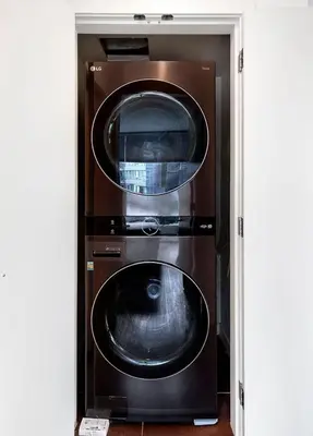 two washer and dryer stacked in a room at Stylish Condo in Downtown in Vancouver