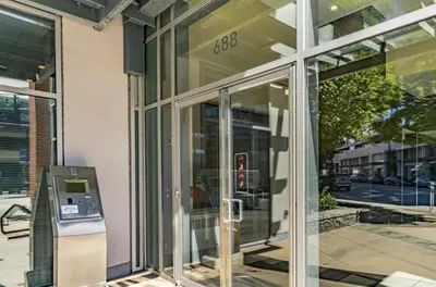 a glass door of a building with a parking meter at Stylish Condo in Downtown in Vancouver