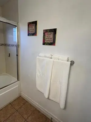 a bathroom with white towels hanging on a wall at Two Bedrooms- A Warm House in Vancouver