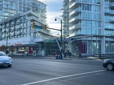 a traffic light on a city street with tall buildings at Two Bedrooms- A Warm House in Vancouver