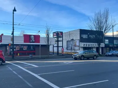 a city street with cars parked in front of buildings at Two Bedrooms- A Warm House in Vancouver