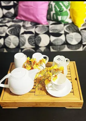 a tray with tea cups and saucers on a table at Two Bedrooms- A Warm House in Vancouver