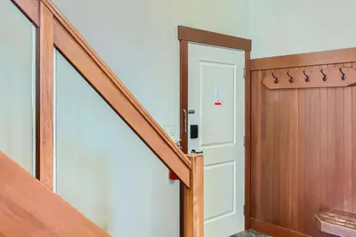 a hallway with a white door and a staircase at Stonegate Resort Unit A403 in Kelowna