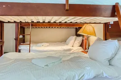 a bedroom with two bunk beds and a lamp at Stonegate Resort Unit A403 in Kelowna