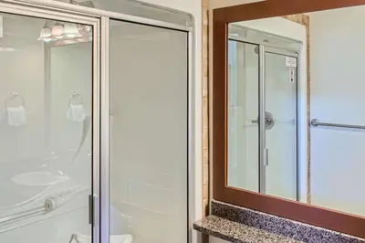 a bathroom with a shower and a mirror at Stonegate Resort Unit A403 in Kelowna