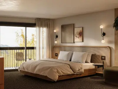 a bedroom with a large bed and a balcony at The Kenrick Hotel in Banff