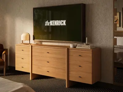 a tv on top of a dresser in a bedroom at The Kenrick Hotel in Banff