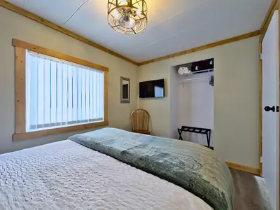 a bedroom with a large bed and a window at Hillcrest Hideaway: Spacious Mountain View Oasis in Hillcrest Mines