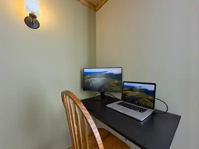 a desk with a laptop and a computer monitor on it at Hillcrest Hideaway: Spacious Mountain View Oasis in Hillcrest Mines