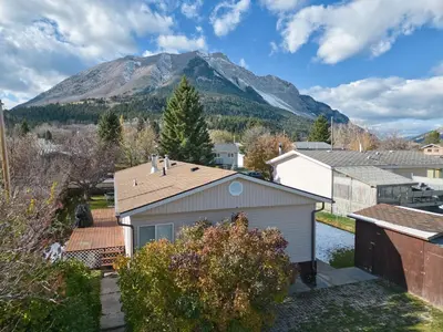 a house with a mountain in the background at Hillcrest Hideaway: Spacious Mountain View Oasis in Hillcrest Mines