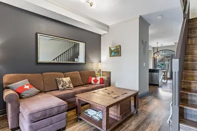 a living room with a couch and a table at Relaxing Mountain Getaway at Mystic Springs in Canmore