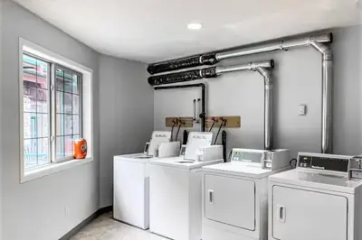 a room with four washing machines and a window at Relaxing Mountain Getaway at Mystic Springs in Canmore