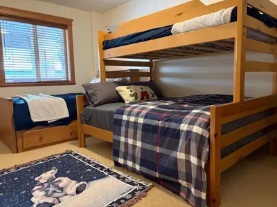 a bedroom with two bunk beds and a bed at Gone Ski 'Inn in Big White