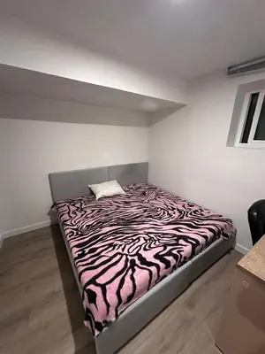a bedroom with a zebra print bed in a room at Sam Estates in Calgary