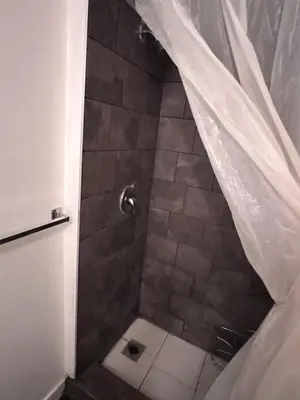 a bathroom with a shower with a shower curtain at Sam Estates in Calgary