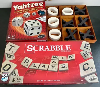 a scrabble board game and dice on a box at All private 2 BRoom w 2 QUEEN BEDS-1 BTHRM-FREE PARKING-FAST WI-FI-CENTRAL LOCATION in Grande Prairie