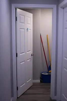 an open white door in a room with baseball bats at Lovely 2Bd 1Bth suite Free pking separated HVAC in Calgary