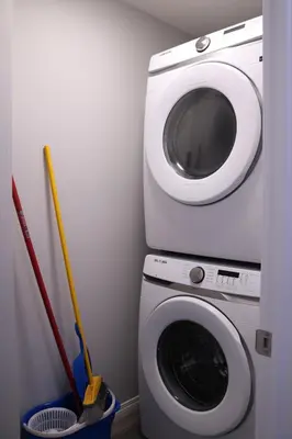 a washing machine and a washer in a room at Lovely 2Bd 1Bth suite Free pking separated HVAC in Calgary
