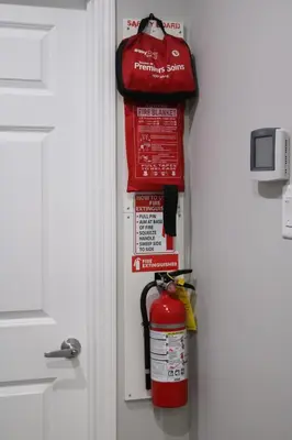 a fire hydrant and a fire extinguisher hanging from a door at Lovely 2Bd 1Bth suite Free pking separated HVAC in Calgary
