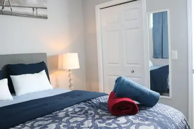 a bedroom with a bed with a red rose on it at Lovely 2Bd 1Bth suite Free pking separated HVAC in Calgary