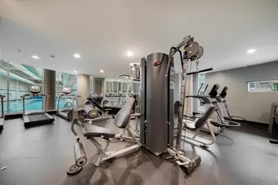 a gym with two treadmills and cardio machines at Great Ocean Mountain & City views with one free parking in Vancouver