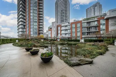 a city with tall buildings and a pond with plants at Great Ocean Mountain & City views with one free parking in Vancouver
