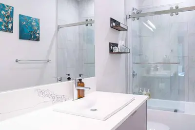 a white bathroom with a sink and a shower at Alpine Retreat by Revelstoke Vacations in Revelstoke