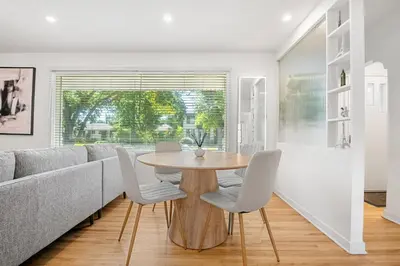 a dining room with a table and chairs and a couch at 3bd Luxury Home, Steps to Calgary DT, River, Hospital in Calgary
