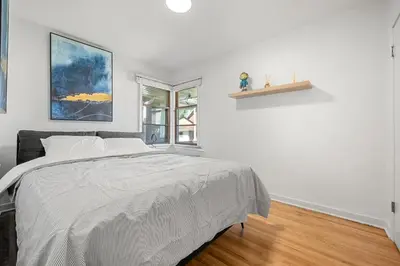 a white bedroom with a bed and a window at 3bd Luxury Home, Steps to Calgary DT, River, Hospital in Calgary