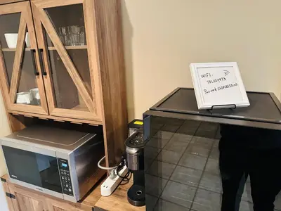 a microwave on a counter with a sign on it at Cozy Home in Dunbar in Vancouver