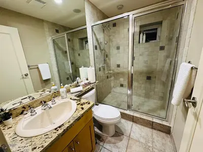 a bathroom with a toilet and a sink and a shower at Cozy Home in Dunbar in Vancouver