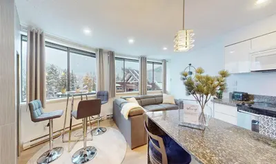 a kitchen and living room with a couch at Whistler village central stay! in Whistler
