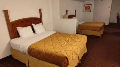 a hotel room with two beds in a room at Metro Inn in Calgary