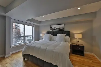 a bedroom with a large bed and a window at Ice District 2 Kings Underground Park Patio in Edmonton