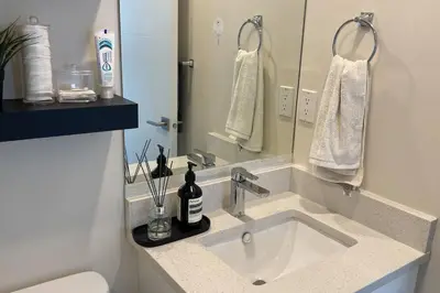 a bathroom with a sink and a mirror at Modern Spacious 1BR minutes away from Main St in Vancouver